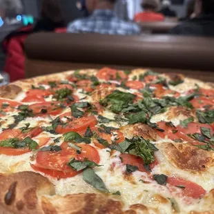 a pizza with tomatoes and basil