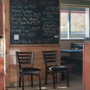two chairs in front of a chalkboard