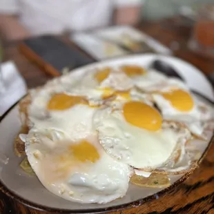 a plate of fried eggs on bread