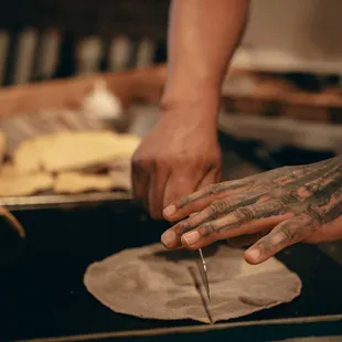 a chef cutting a tortilla