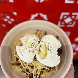 a person holding a bowl of food