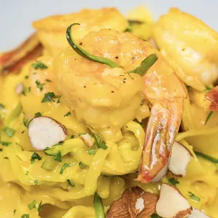 a plate of pasta with shrimp and almonds