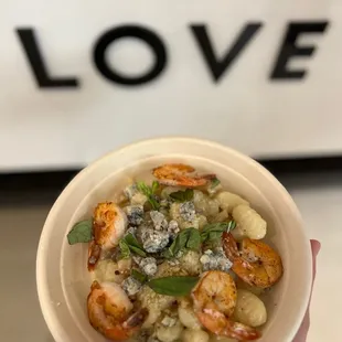 a hand holding a bowl of food