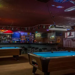 two pool tables and a bar