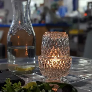 a table with salad and a candle