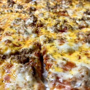 Cheese sausage, thin crust pizza with cheddar cheese added