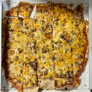 Cheese sausage, thin crust pizza with cheddar cheese added