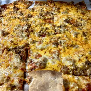 Cheese sausage, thin crust pizza with cheddar cheese added