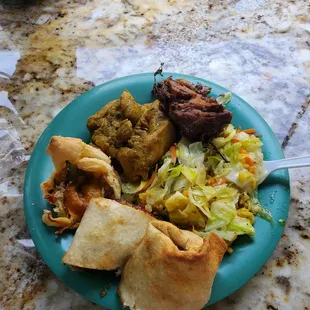 Beef wrap, curry chicken, jerk seasoned pork, steamed vegetables over a bed of yellow rice.