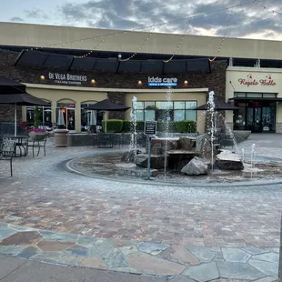 a fountain in front of a restaurant