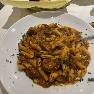 a plate of pasta and a basket of bread