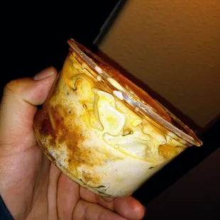 a person holding a bowl of food