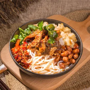 a bowl of noodles and meat