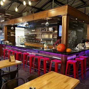 a bar with red stools