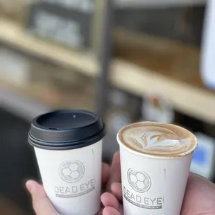 a hand holding a cup of coffee