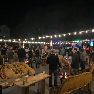 a crowd of people gathered around a fire pit
