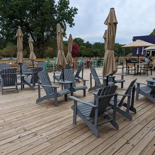 a deck with chairs and umbrellas