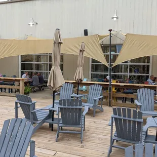 tables and chairs with umbrellas