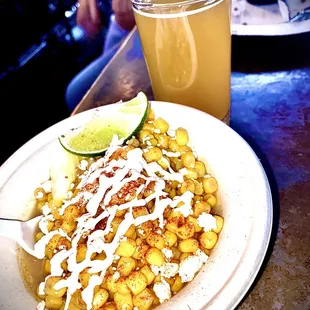 a plate of mexican food and a glass of beer