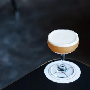 a drink in a glass on a table