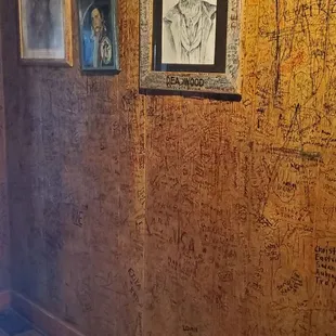 a wooden wall with graffiti on it