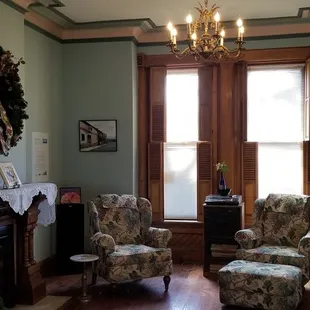 a living room with a fireplace and a chandelier