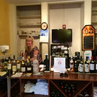 Leslie in her shop ready to pour tastings of a variety of wines...