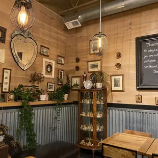a dining area with a chalkboard on the wall
