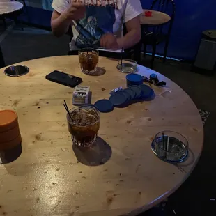 a man sitting at a table with drinks