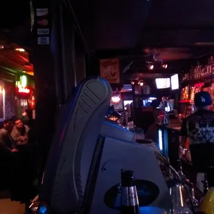 At the corner of the bar.