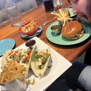 Steak tacos with onion straws and cheeseburger with fries