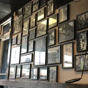 a wall of framed photographs