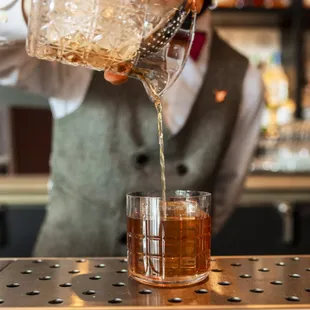 a bartender pouring a drink
