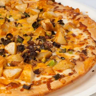 The Travis- Creamy ranch sauce, seasoned potato wedges, crumbled bacon, green onions, mozzarella and cheddar cheese