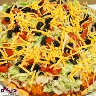 Taco Pizza- Special spicy sauce, beef, onions and mozzarella cooked. After, we add fresh shredded lettuce, tomatoes, olives and cheddar.