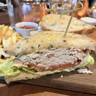 Turkey BLT with Bibb lettuce, heirloom tomatoes, and a garlic aioli, served with fries