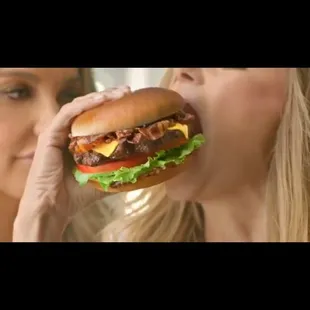 a woman eating a hamburger