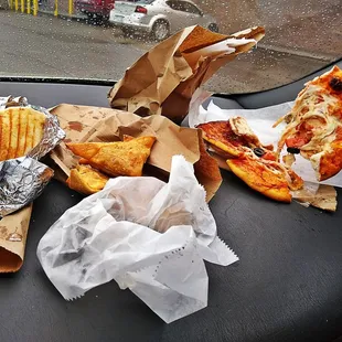 a person holding a slice of pizza