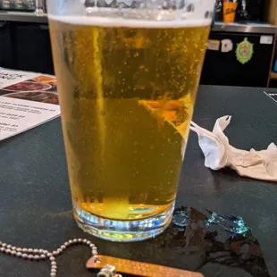 a pint of beer on a bar