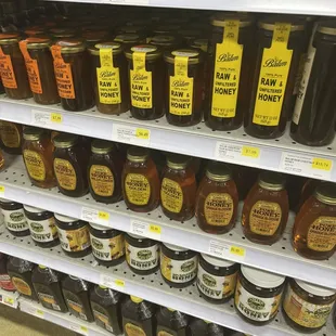 a variety of honeys on shelves