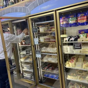 a man standing in front of a refrigerator