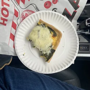 Half eaten spinach and feta breakfast pizza
