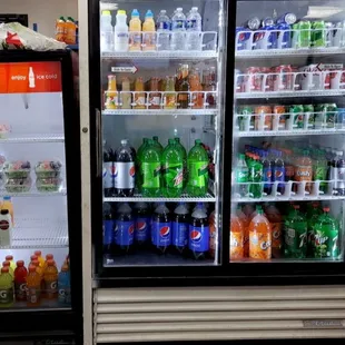 two refrigerators filled with drinks
