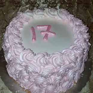 a pink frosted birthday cake