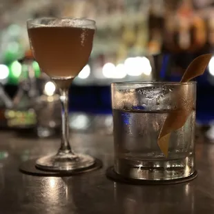 two cocktails on a bar