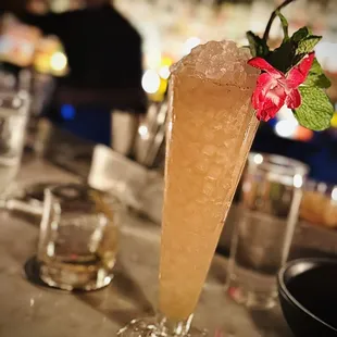 a tall glass filled with a drink