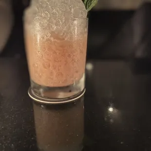 a close up of a drink with ice and mint