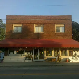 a brick building with a red awning