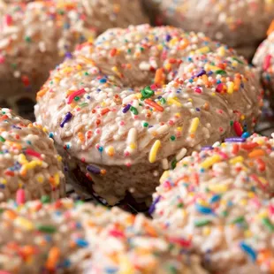a bunch of donuts with sprinkles