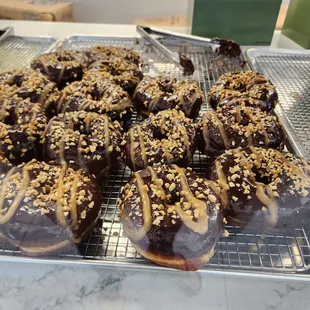 chocolate covered donuts on a cooling rack